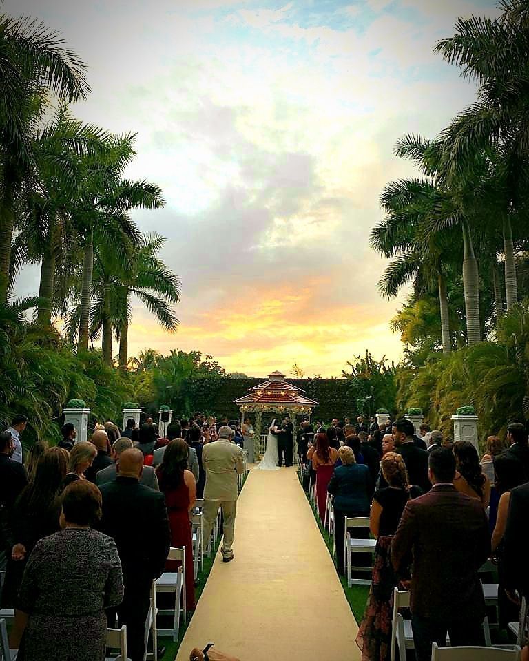 Wedding ceremony at sunset beneath the palms