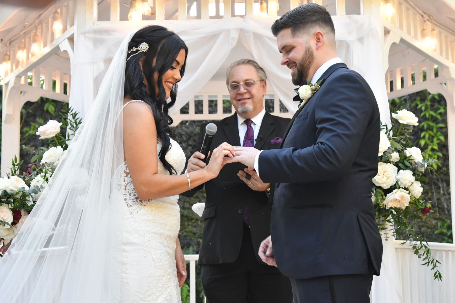 Exchange of rings during an outdoor wedding ceremony