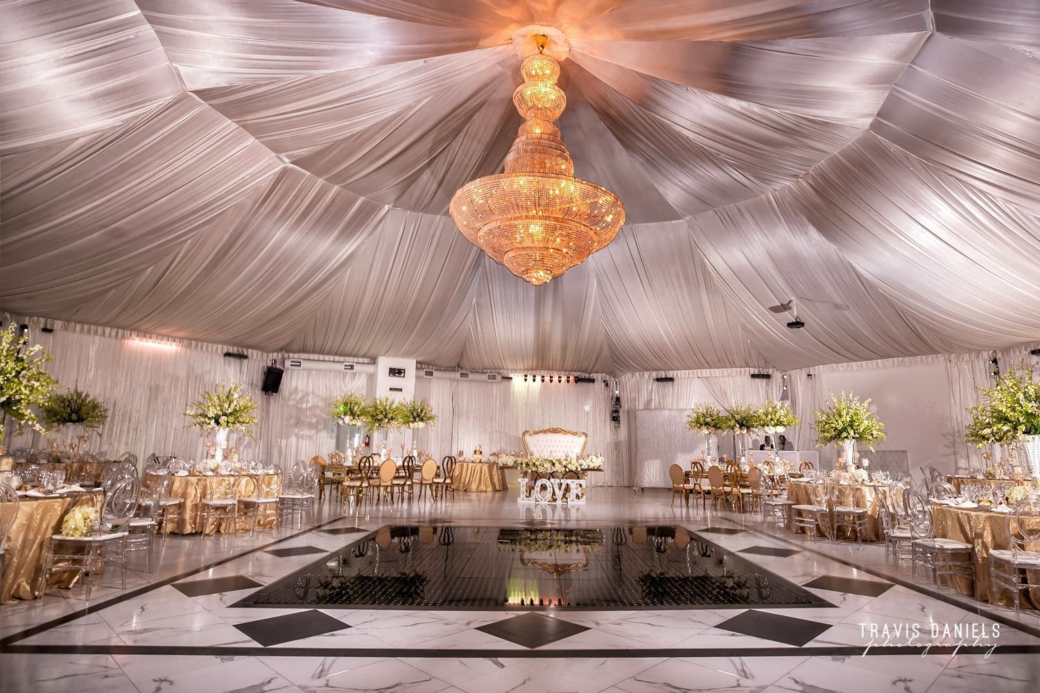 Luxury wedding reception beneath the chandeliers