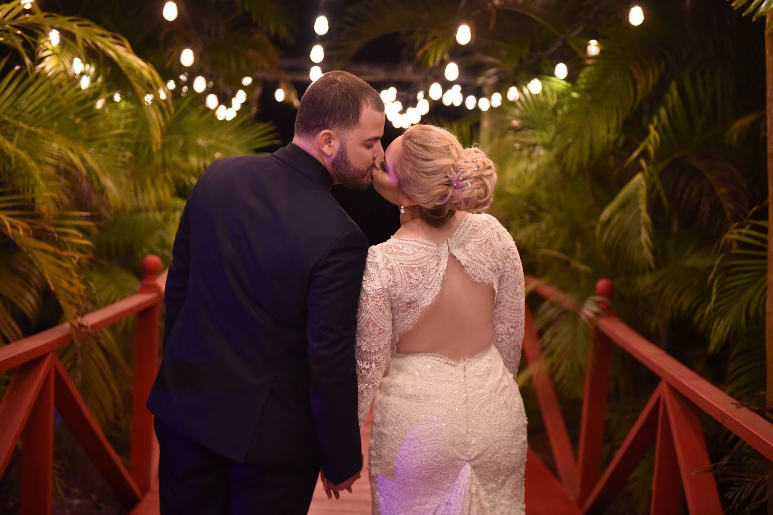 Newlyweds on the illuminated garden bridge